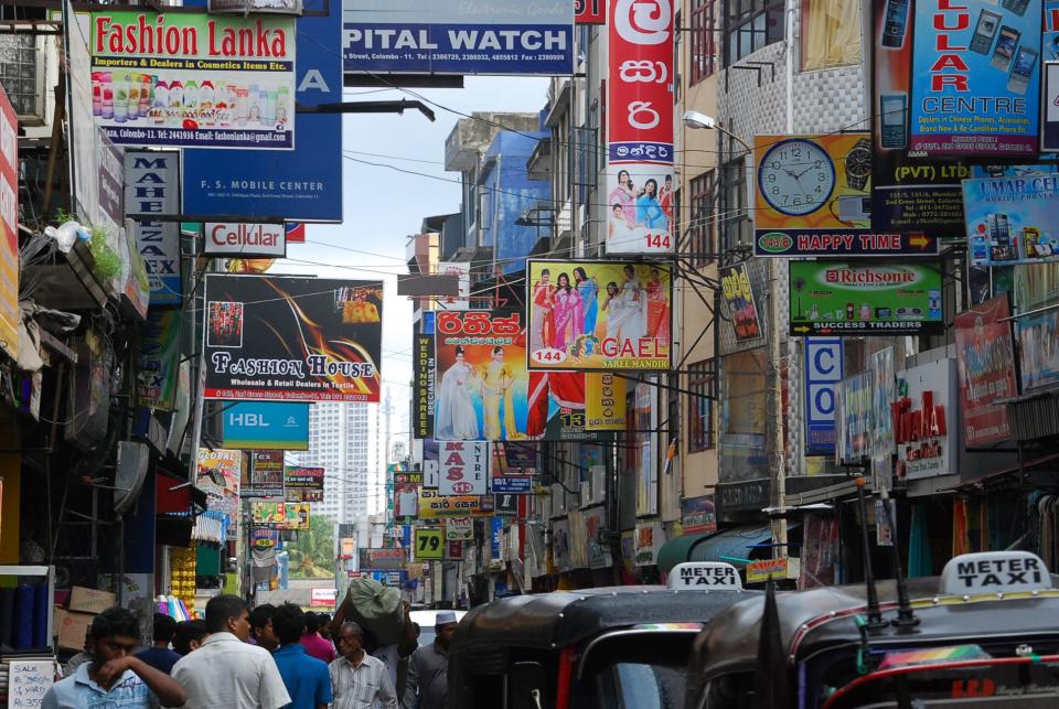 India, Indians, people, city, streets, traffic, taxis, cars, crowd, pedestrians, signs, stores, shops, buildings