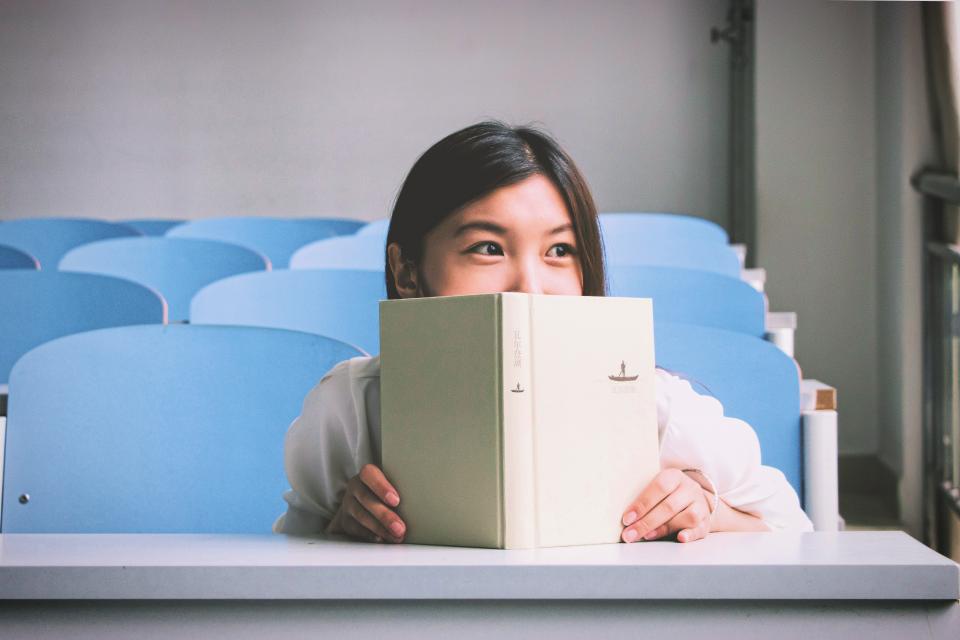 girl, student, school, book, classroom, chairs, smile, smiling, happy, education, reading, people